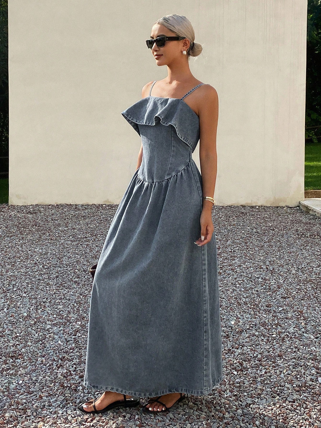 This sophisticated denim dress combines timeless style with modern details. The cinched waist creates a flattering silhouette that defines your figure, while the delicate ruffle trim adds movement and visual interest. Crafted from quality denim, it transitions seamlessly from casual daytime wear to evening occasions. The thoughtful design balances structure with comfort, making it an essential piece for any wardrobe. Perfect for those who appreciate refined simplicity without sacrificing personality.