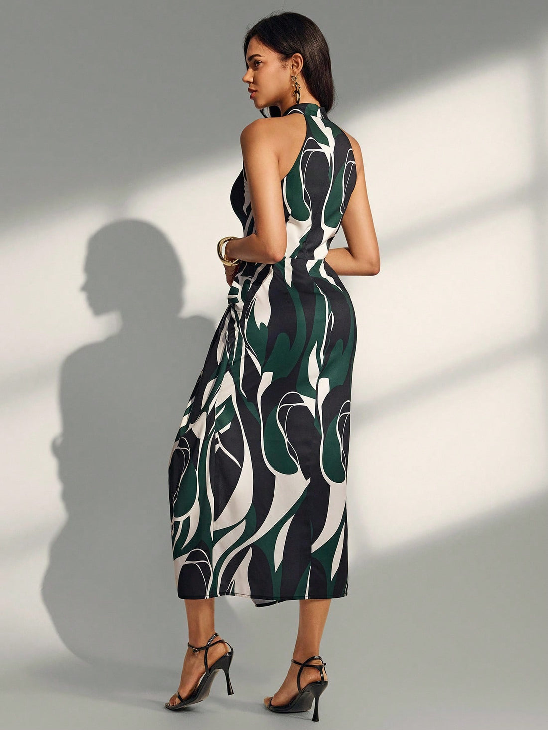 Effortlessly chic meets laid-back cool with the Alma Muse Sleeveless Long Dress. This spring and summer essential features a breezy sleeveless silhouette, eye-catching geometric print, and a playful button tie detail that lets you customize your look. The strategic slit adds movement and flair, making it perfect for everything from casual brunches to sunset strolls. Lightweight and versatile, it's the dress that does it all without trying too hard.