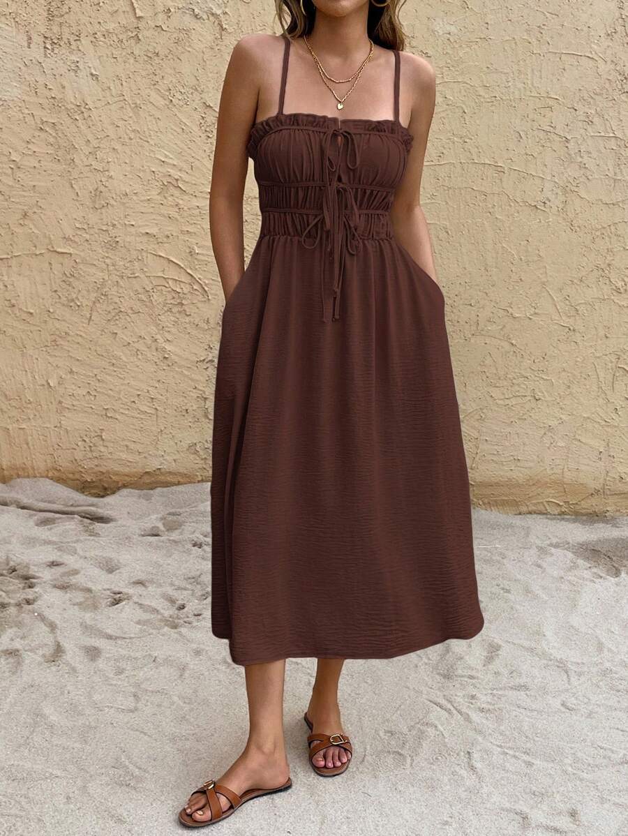 Close-up brown midi sundress with ruched bust front ties and textured fabric
