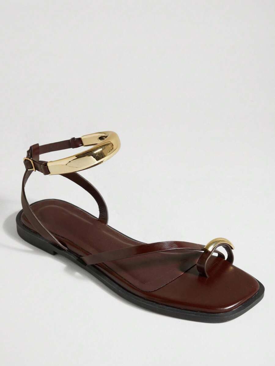 Side view of chocolate brown toe-post sandals with square footbed and ankle strap