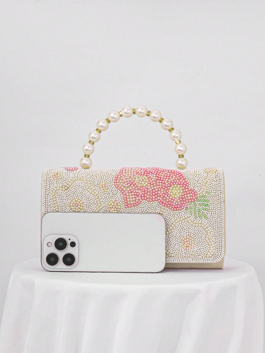 Add a touch of whimsy to your evening look with this Chic Pearl Flower Print Evening Clutch. Its delicate pearl flower design brings a playful charm while keeping things elegant, perfect for turning heads at formal events and celebrations. Compact yet roomy enough for your essentials, this clutch is your new go-to for stylish nights out.