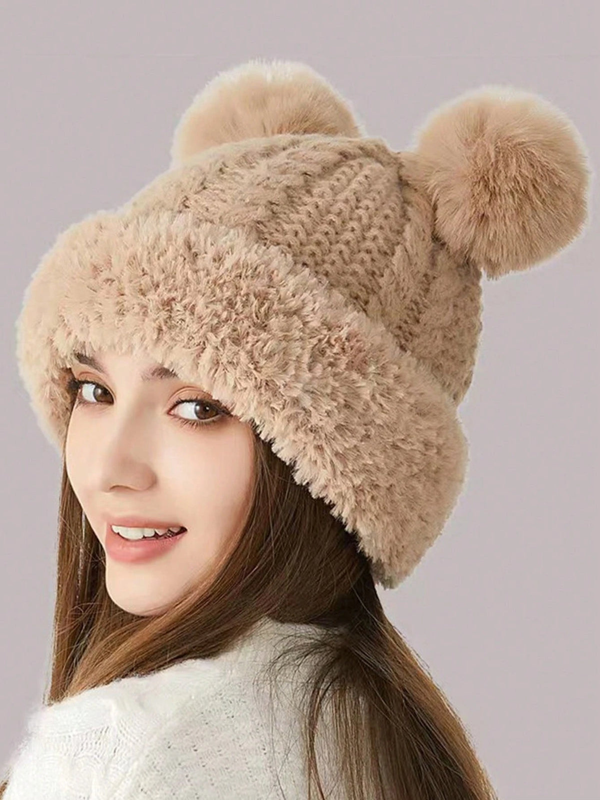 Side view of beige knit bear-ear hat with textured crown and fuzzy edge