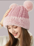 Close front view of blush pink knit bear-ear hat with fuzzy trim