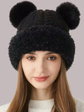 Front portrait of model in black fuzzy bear-ear hat with rounded pom ears