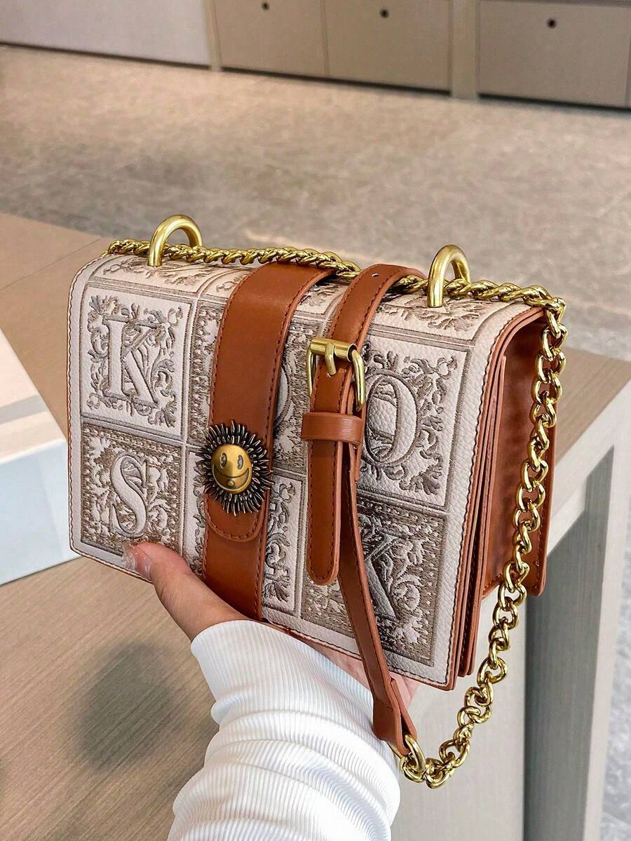 Interior of mini box crossbody bag showing zipper divider and flap closure