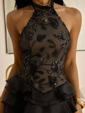 Black halter-style sequin mini dress with sheer bodice