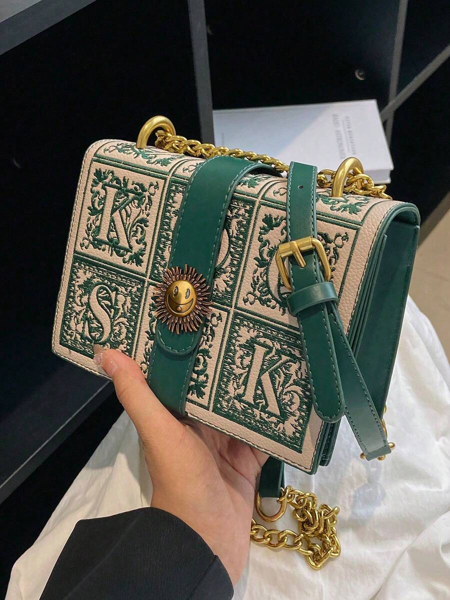 Side view of cream green box crossbody bag with gusseted body and gold hardware