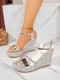 Side view of silver wedge sandals with glitter sole and rubber tread