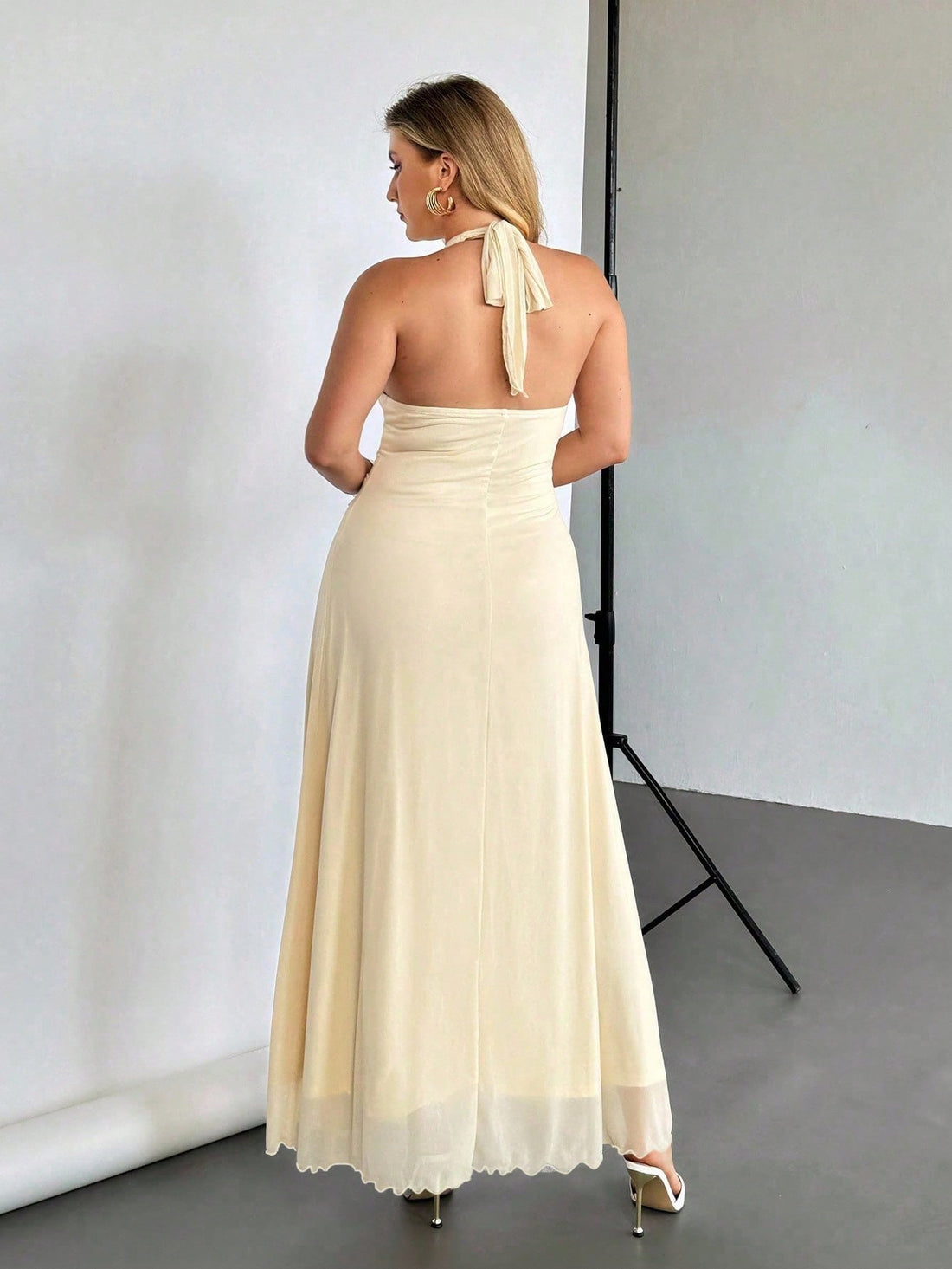 Elevate your summer wardrobe with this stunning halter dress designed for confident curves. The draped neckline creates a flattering silhouette while the tie waist cinches beautifully to define your shape. Perfect for everything from casual brunches to evening outings, this plus-size piece combines comfort with undeniable style. The flowing fabric moves with you, making it an instant go-to for warm-weather occasions when you want to look and feel fabulous.