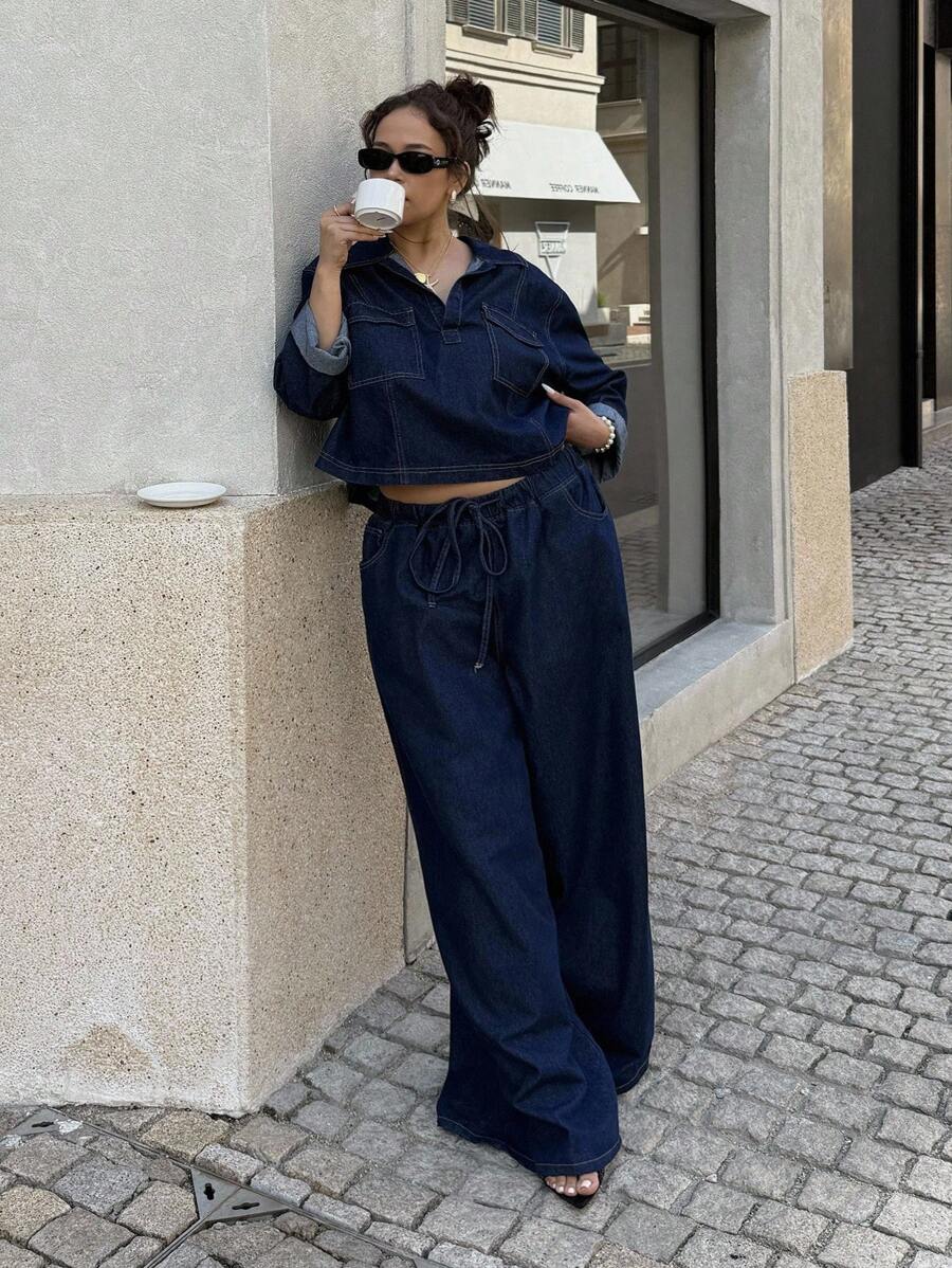 Front view of dark indigo plus size denim two-piece set with cropped pocket top and wide-leg pants
