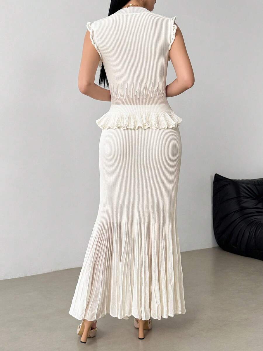 Elevate your wardrobe with this sophisticated 2-piece set featuring a sleeveless knit vest with a refined stand collar paired with a graceful long pleated skirt. Crafted from 100% viscose with medium stretch for comfort and movement, this ensemble offers a slim fit silhouette perfect for daily wear, reunions, and special occasions. The white colorway exudes timeless elegance, while the thoughtful design works beautifully for both casual gatherings and festive celebrations. Hand wash or professionally dry cl