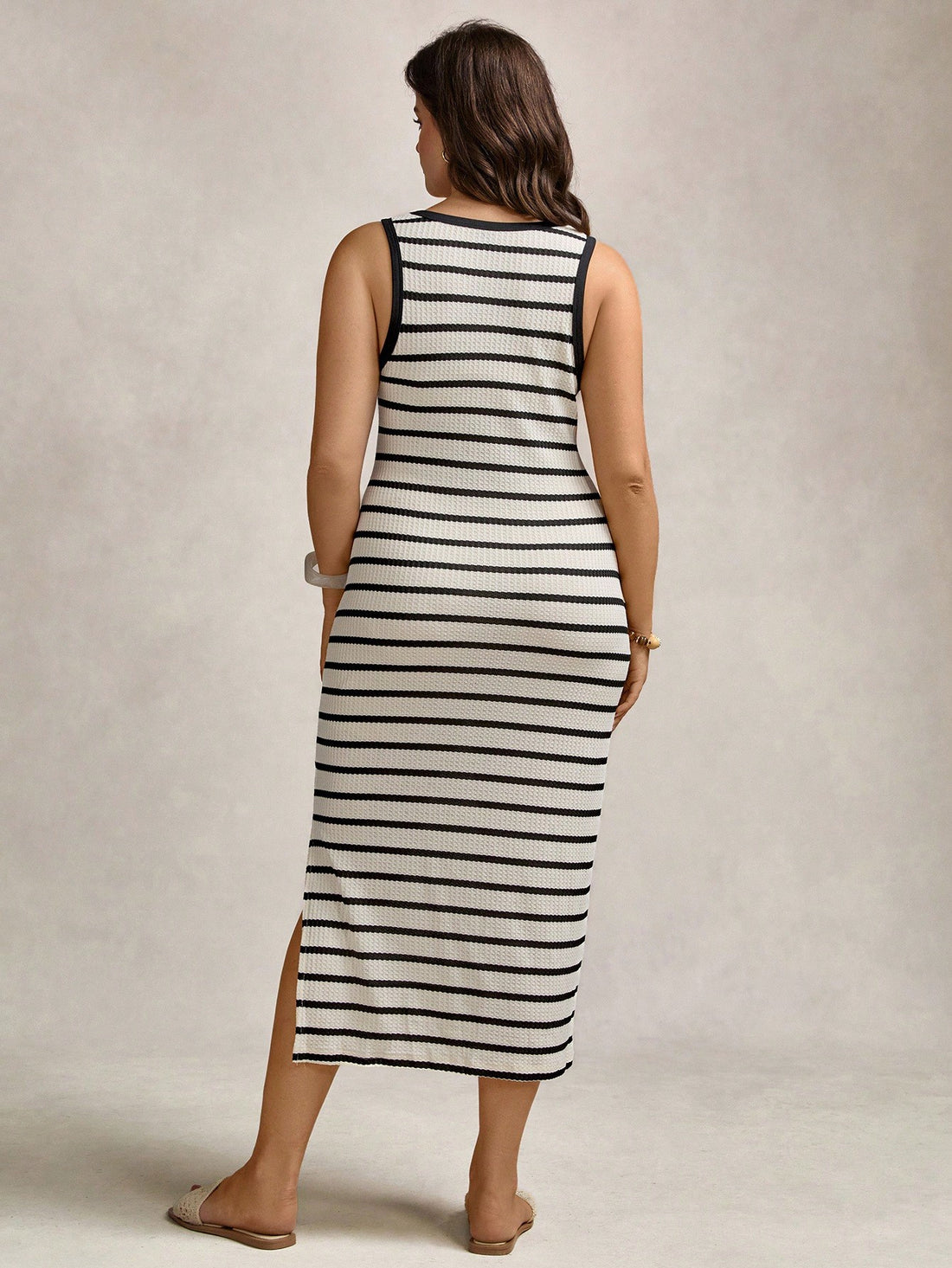 Step out in style with this playful plus size black and white striped midi dress. Featuring a flattering side slit, it effortlessly blends comfort with flair—ideal for casual days, resort escapes, or office hours with a twist. The classic stripes add a timeless vibe while the flowy fit ensures you stay comfy and confident all day long. Dress it up or down and enjoy those heads turning wherever you go!