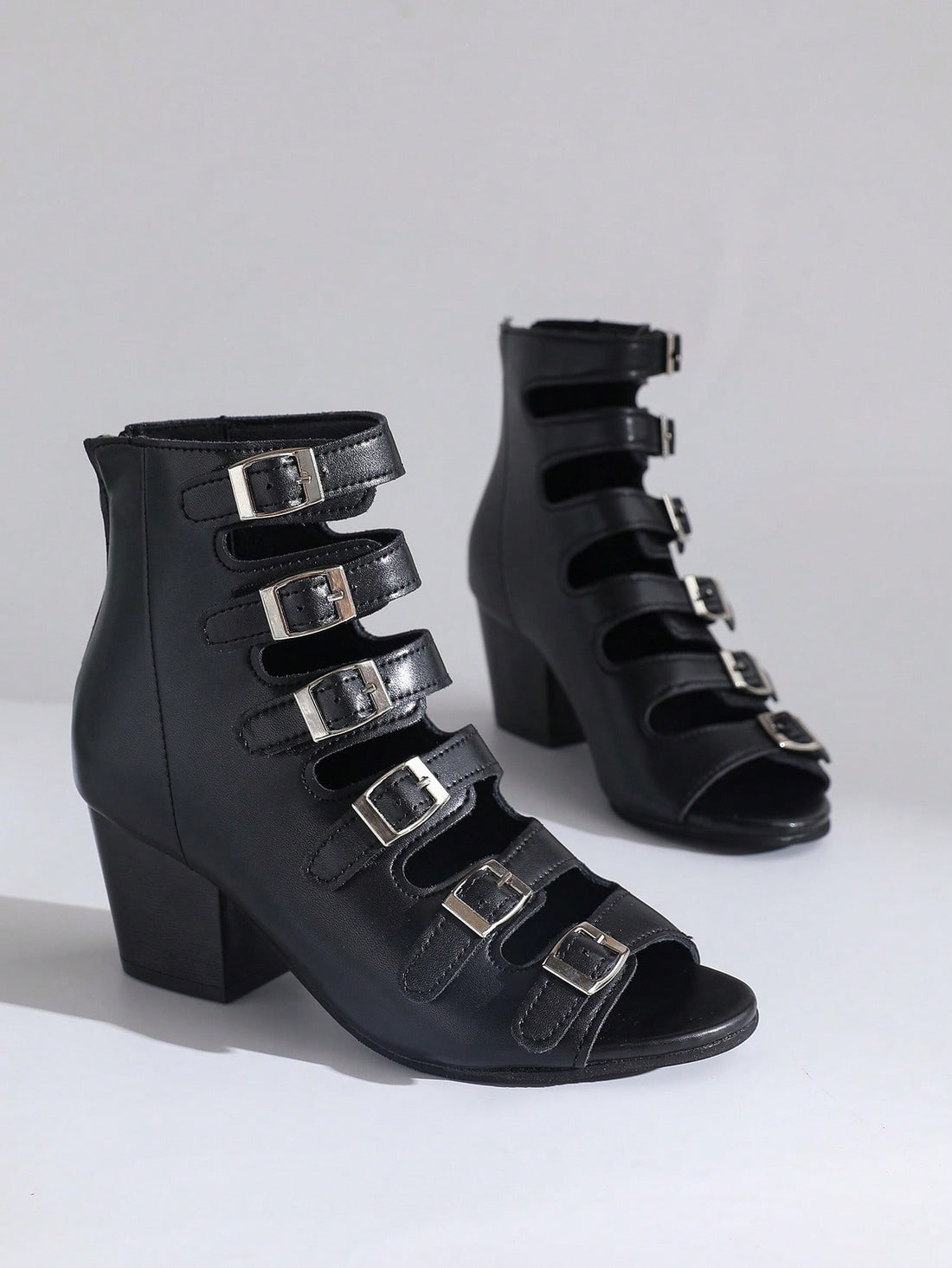 Step up your summer party game with these trendy women's black punk-style ankle boots. Featuring bold belt buckles and chunky thick heels, they add the perfect edgy twist to any outfit. Comfortable yet striking, these boots let you dance the night away while making a fierce fashion statement. Perfect for those who dare to stand out!