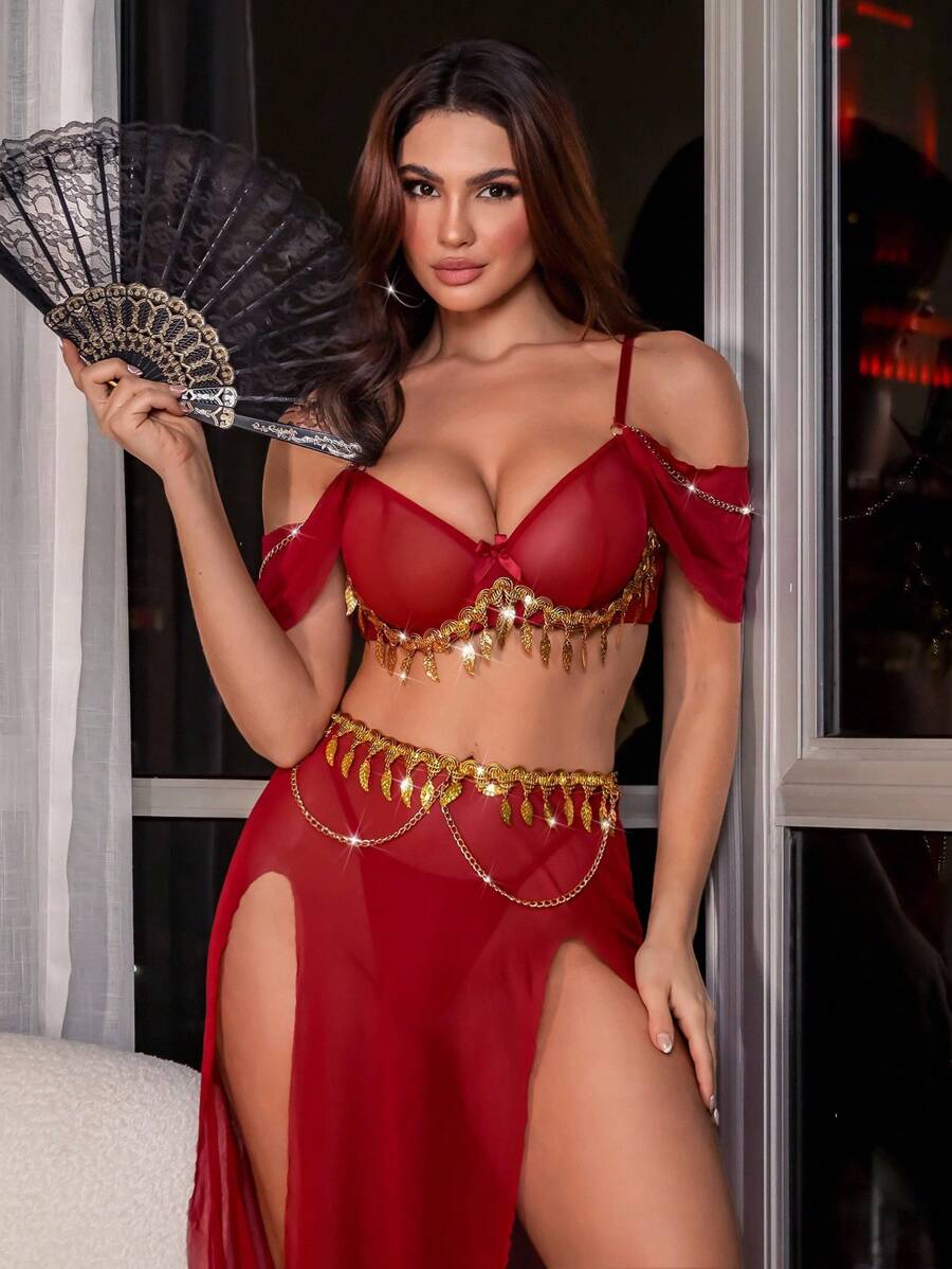 Burgundy mesh bra set with draped sleeves, gold tassels, and slit maxi skirt