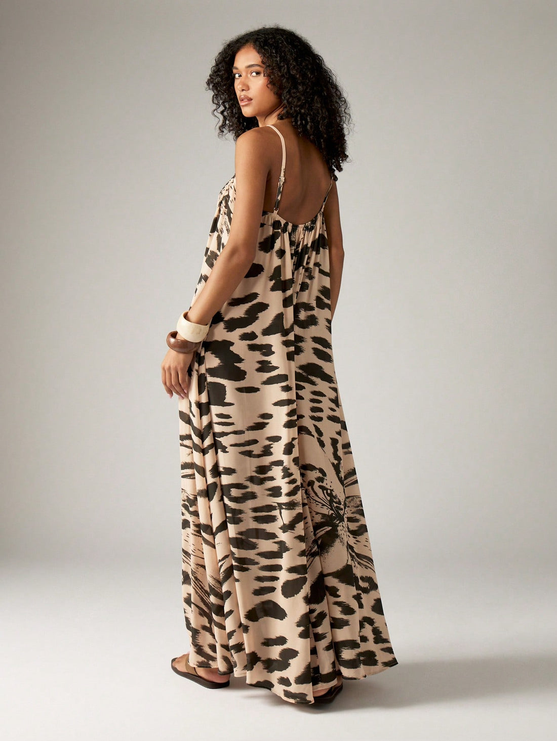 Unleash your wild side with our Effortlessly Chic Leopard Print Maxi Dress! Perfect for summer beach getaways, this dress features a flowy trapeze design and spaghetti straps for a comfortable and breezy fit. Stand out in style with this playful and trendy addition to your wardrobe.
