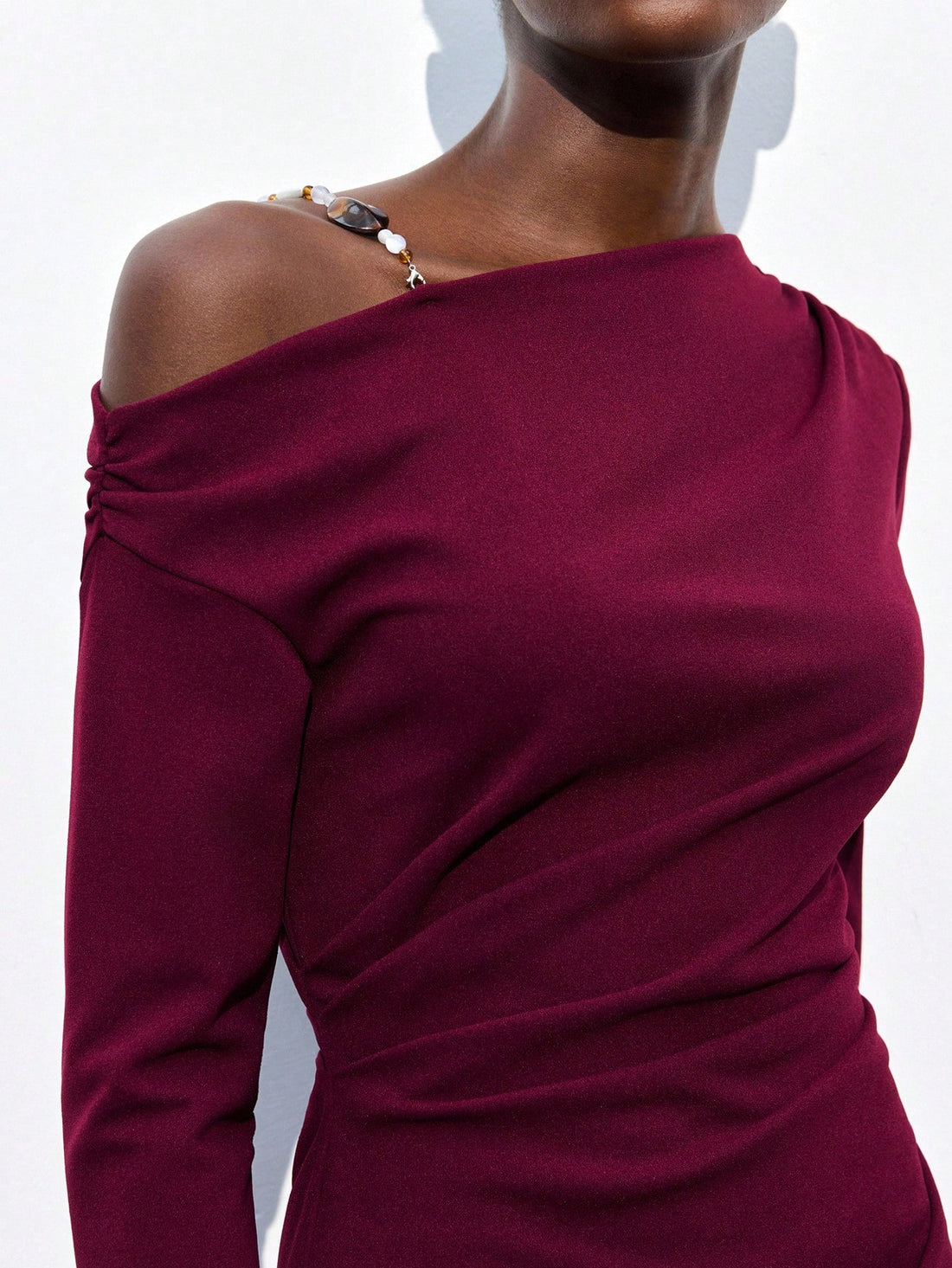 Turn heads with this playful yet sophisticated wine-colored dress featuring an asymmetrical shoulder design and flattering ruched details. Its mid-length cut offers just the right balance of elegance and fun, perfect for any occasion that calls for a touch of flair. Feel confident and effortlessly chic while enjoying the unique silhouette that adds a dash of whimsy to your wardrobe.
