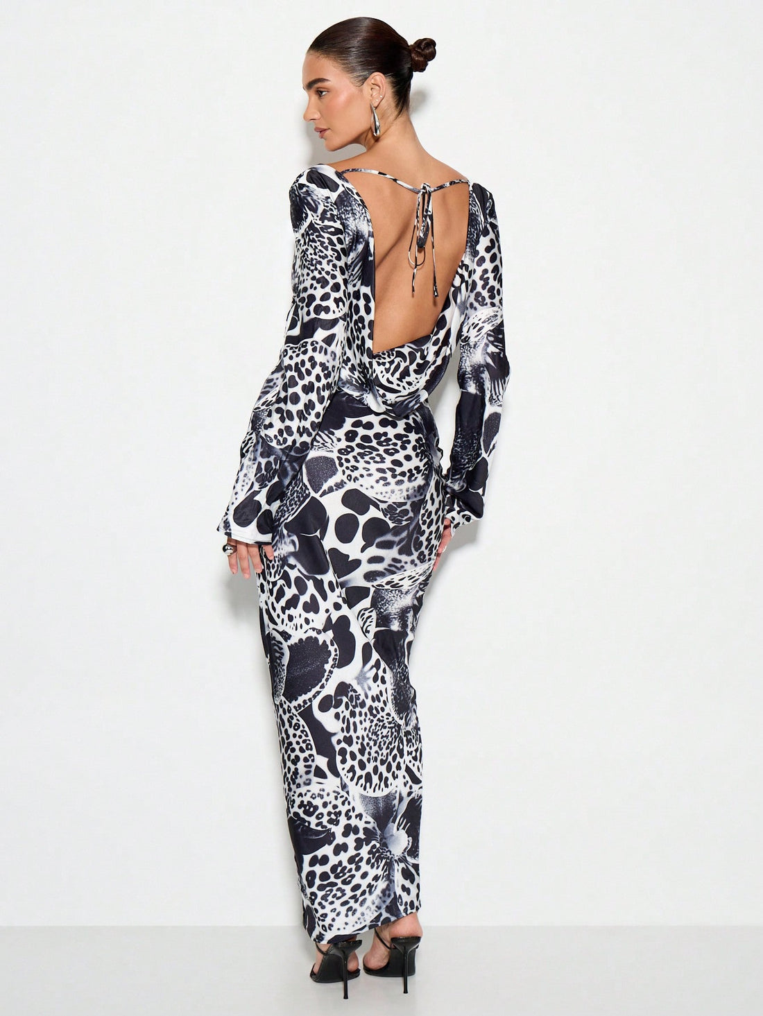 Make a statement at your next winter soirée in this stunning animal print maxi dress. The daring cut-out waist adds modern edge while the flowing silhouette flatters every figure. Crafted for those who love bold patterns and aren't afraid to turn heads, this dress transitions effortlessly from holiday parties to formal galas. The maxi length keeps things sophisticated, while the playful print brings personality to any occasion. Slip it on and let your confidence do the talking.