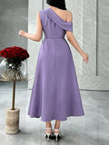 Close front detail of lavender purple one-shoulder midi dress with layered ruched waist in marble interior