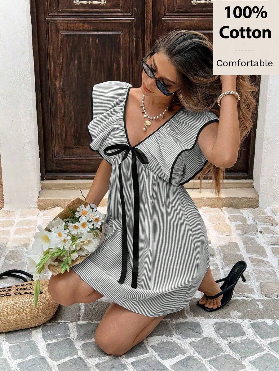 Stripes never go out of style—especially when they're this charming! This cotton mini babydoll dress combines classic blue and white stripes with a flowy silhouette that's equal parts cute and comfortable. Whether you're dashing to work, catching waves at the beach, or grabbing coffee with friends, this versatile piece transitions effortlessly from day to night. The breathable cotton fabric keeps you cool when temperatures rise, while the relaxed fit lets you move freely. Simple, sweet, and endlessly wearab