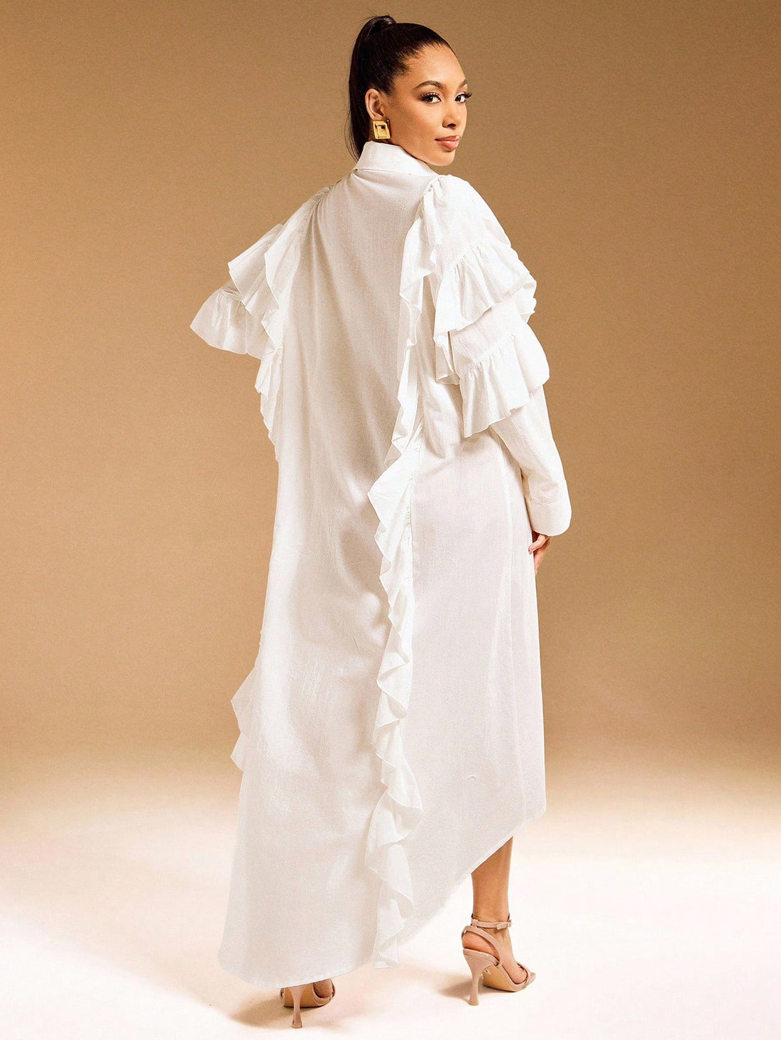 Elevate your everyday wardrobe with this charming shirt dress that effortlessly transitions from brunch to dinner. Crafted from quality woven fabric, it features a crisp button-up collar, playful ruffle detailing, and a flattering hi-low hemline that keeps things interesting. The solid color makes it a versatile closet staple that pairs beautifully with sneakers, sandals, or heels. Dress it up or down—this piece is your new go-to for looking put-together without trying too hard.