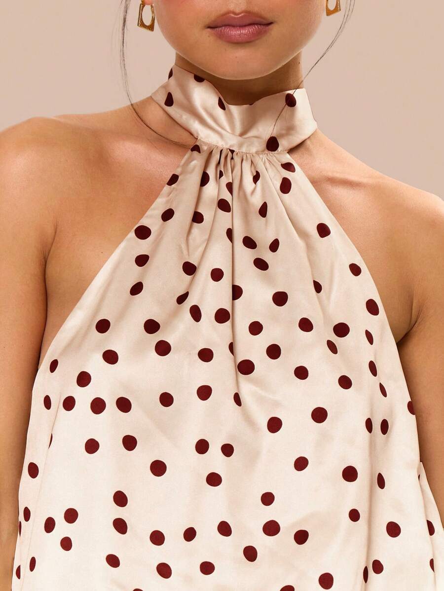 Step into the spotlight with this playful satin mini dress, featuring a chic halter neck and timeless polka dots. Perfect for birthdays, graduations, and sunny celebrations, its smooth fabric and flirty cut keep you comfortable and stylish all day and night. Celebrate in a dress that’s as fun and fabulous as the occasion!