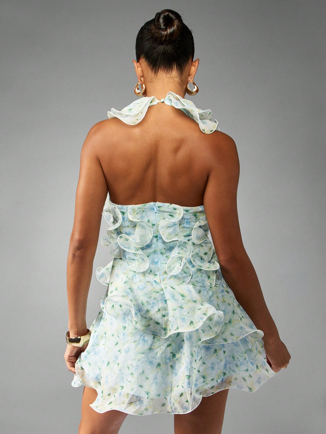 This playful chiffon mini dress bursts with vibrant floral charm, perfect for spring and summer celebrations. Its ruffle halter neck adds a flirty touch, while the lightweight fabric keeps you cool and comfortable all day or night. Ideal for weddings, garden parties, or any sunny occasion where you want to shine with effortless style.