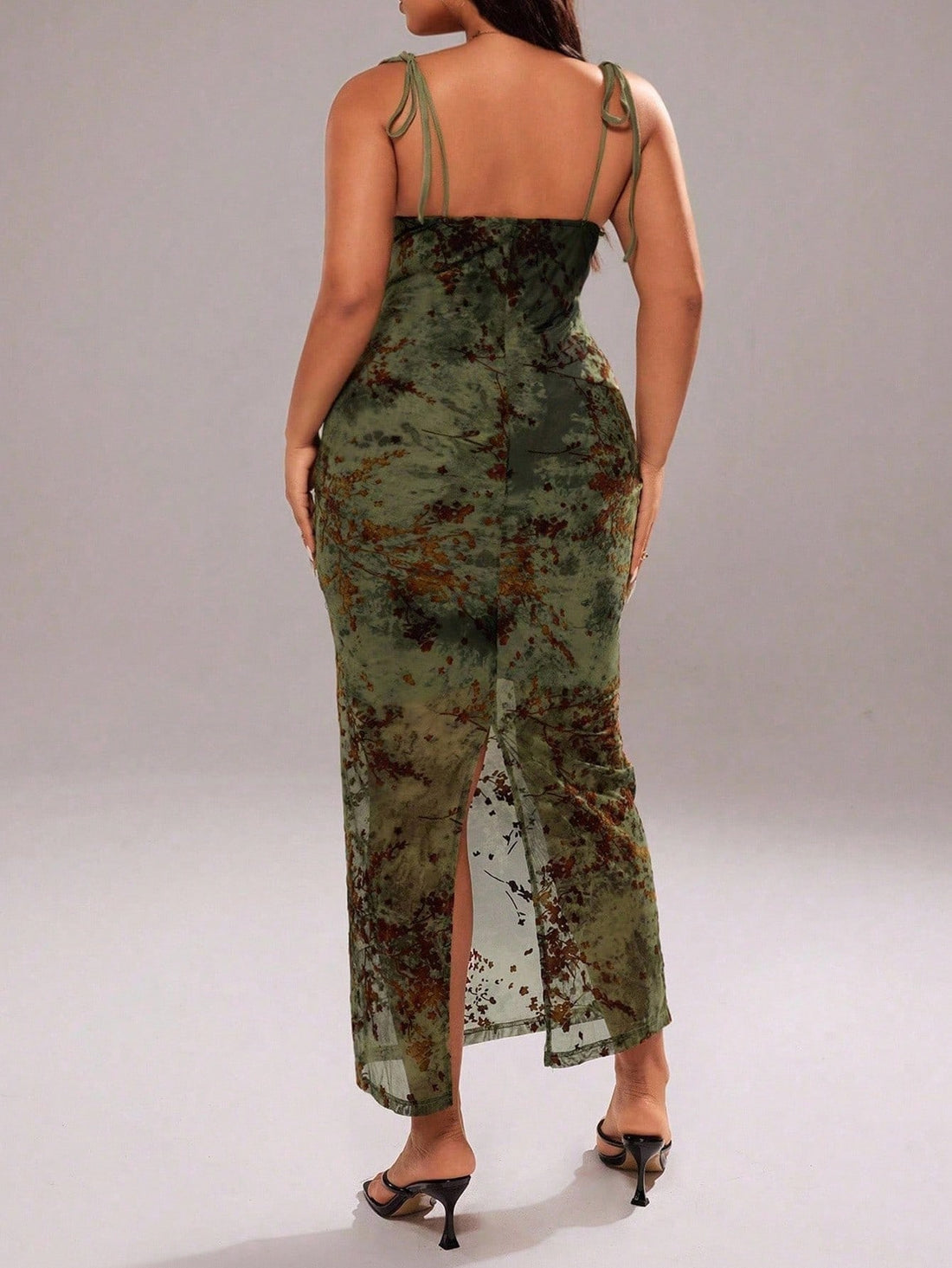 Turn heads in this bold plus-size dress that's equal parts flirty and fabulous. The delicate spaghetti straps frame your shoulders while the front knot detail adds a cheeky touch of allure. A daring backless design and thigh-high split keep things exciting, while sheer mesh accents bring just the right amount of edge. Perfect for nights when you want to feel confident, sexy, and absolutely unforgettable.