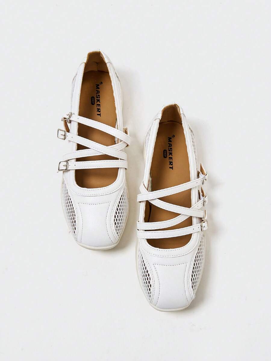 Overhead view of white rounded-square toe Mary Jane flats with three buckle straps