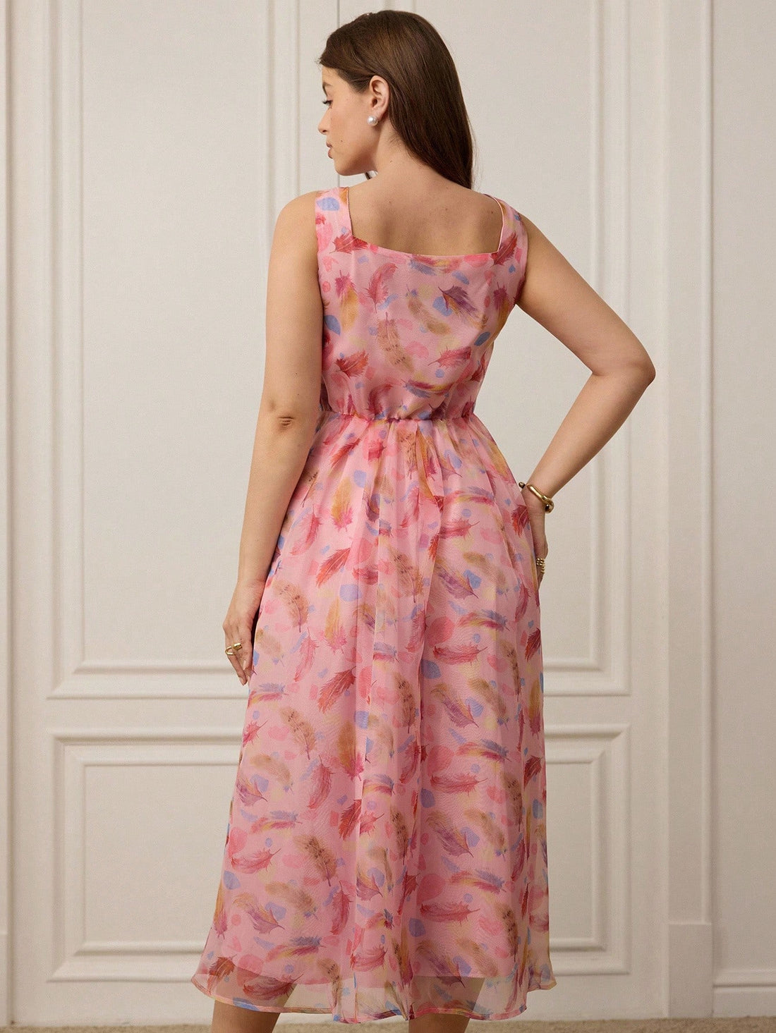 Step into summer with this Elegant Plus Size Pink Chiffon Dress, shimmering with a delicate feather print that flutters with every breeze. Its lightweight chiffon fabric keeps you cool while adding a touch of grace to your look. Designed to celebrate curves, this dress blends comfort and charm effortlessly—perfect for sunlit days and starry nights. Embrace the playful spirit of summer with flowing elegance that moves as freely as you do.