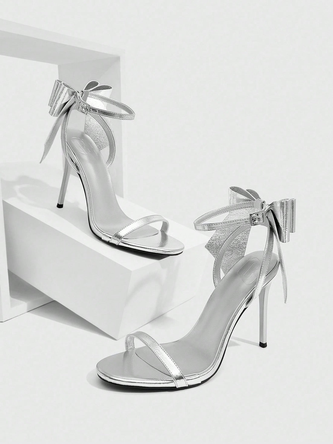 Step out in style with these Elegant Silver Butterfly Decor Mid-Heel Sandals. The shimmering silver finish and delicate butterfly embellishment add a touch of whimsy, while the ankle strap ensures a secure, comfortable fit. Perfect for dancing the night away or adding sparkle to any outfit, these sandals combine charm and comfort effortlessly.