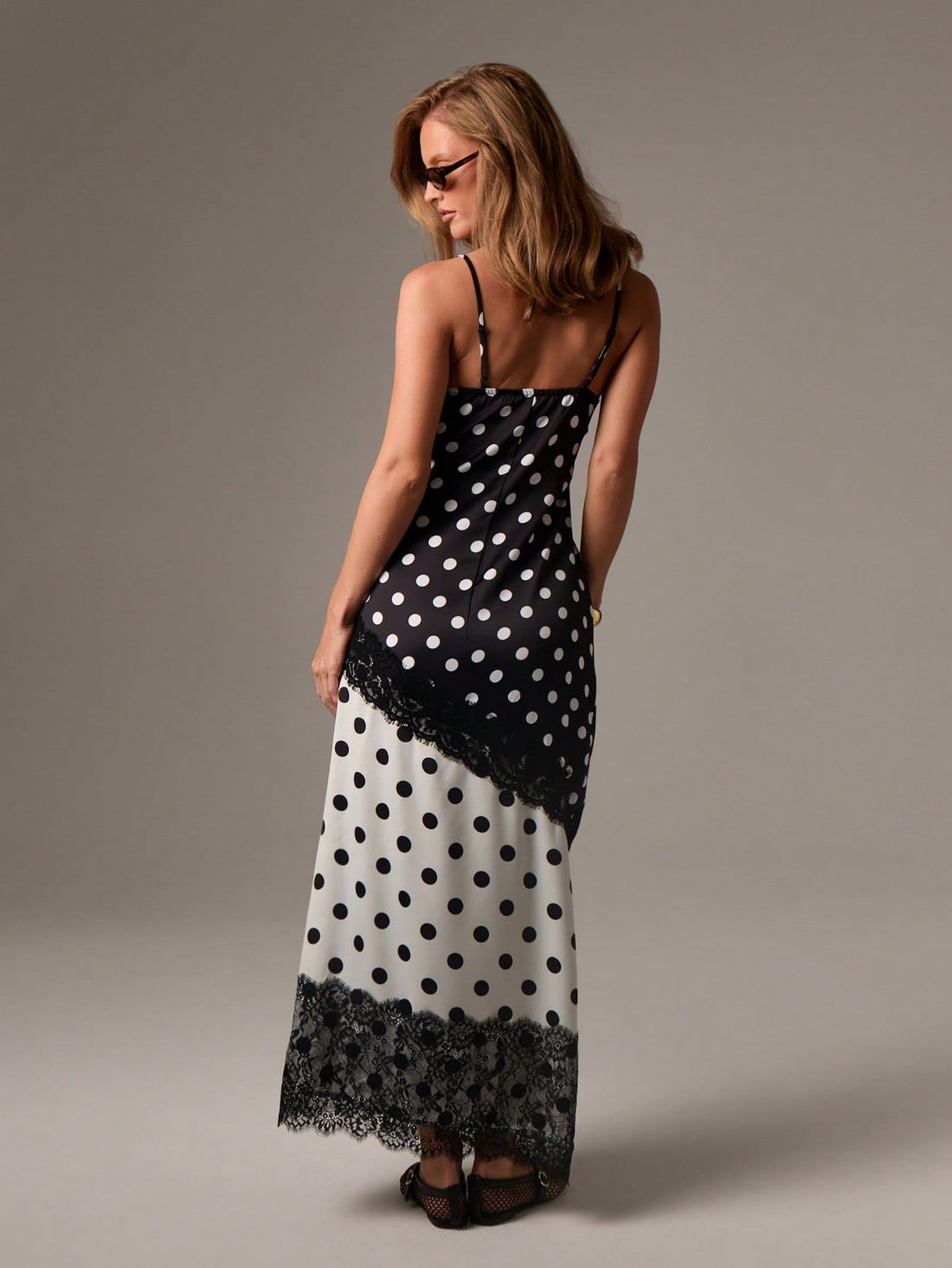 Step into effortless charm with this Chic Polka Dot Maxi Dress featuring delicate lace trim. Light and breezy, it's the perfect pick for spring and summer weddings or evening soirées. The playful polka dots add a fun twist while the flowing maxi silhouette keeps you comfortable and stylish all night long. Elevate your event wardrobe with this flirty and elegant dress that makes every occasion feel special.