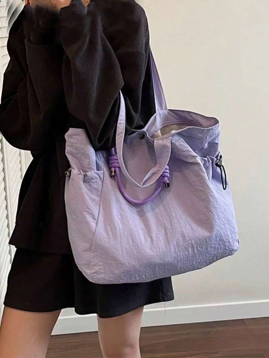 Tote it all with style! This lightweight nylon tote is your go-to companion for everything from textbooks to gym gear. With generous interior space and comfortable shoulder straps, it transitions seamlessly from campus to coffee runs to weekend adventures. The durable nylon construction keeps up with your busy lifestyle, while the sleek design works with any outfit. Whether you're heading to class, the gym, or just need a reliable everyday bag, this versatile tote has your back—literally!