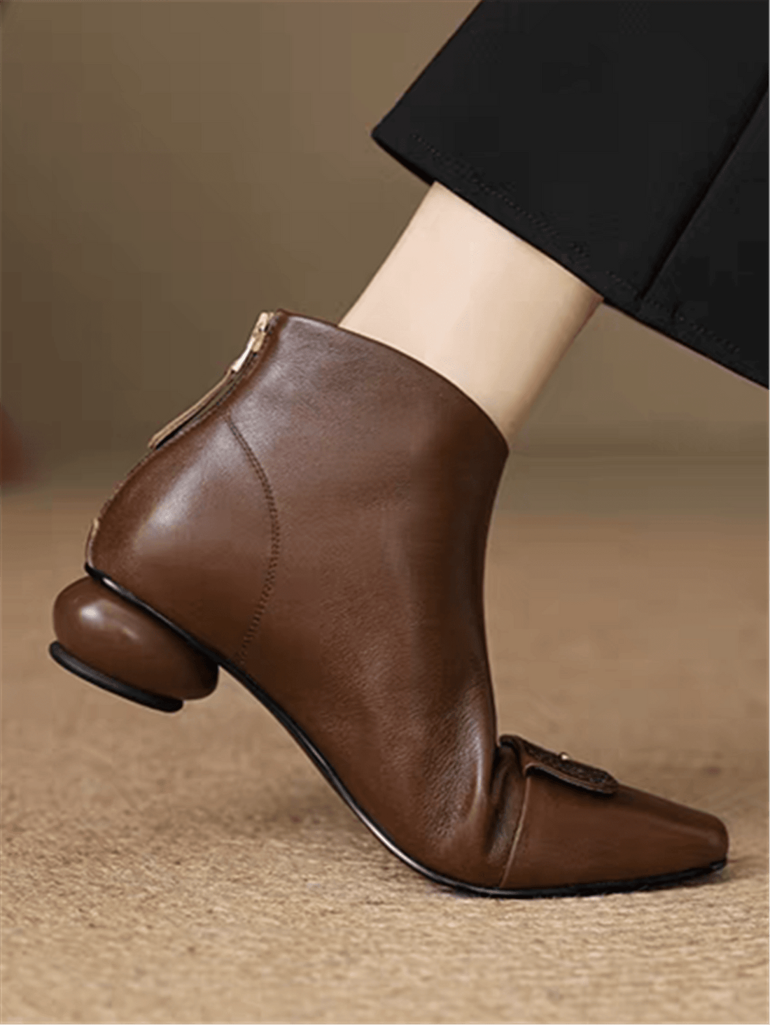 Step into sophistication with these chic pointed-toe short boots that blend minimalist elegance with edgy flair. Featuring a sleek silhouette and eye-catching metal plate detailing, they're the perfect statement piece for elevating your fall and winter wardrobe. Whether you're dressing up for a night out or adding polish to everyday looks, these boots deliver that coveted balance of refined style and bold personality. Comfortable enough for all-day wear, they're your new go-to for turning heads and feeling 