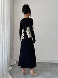 Back full view of black and cream floral slim-fit knit midi dress with subtly flared hem