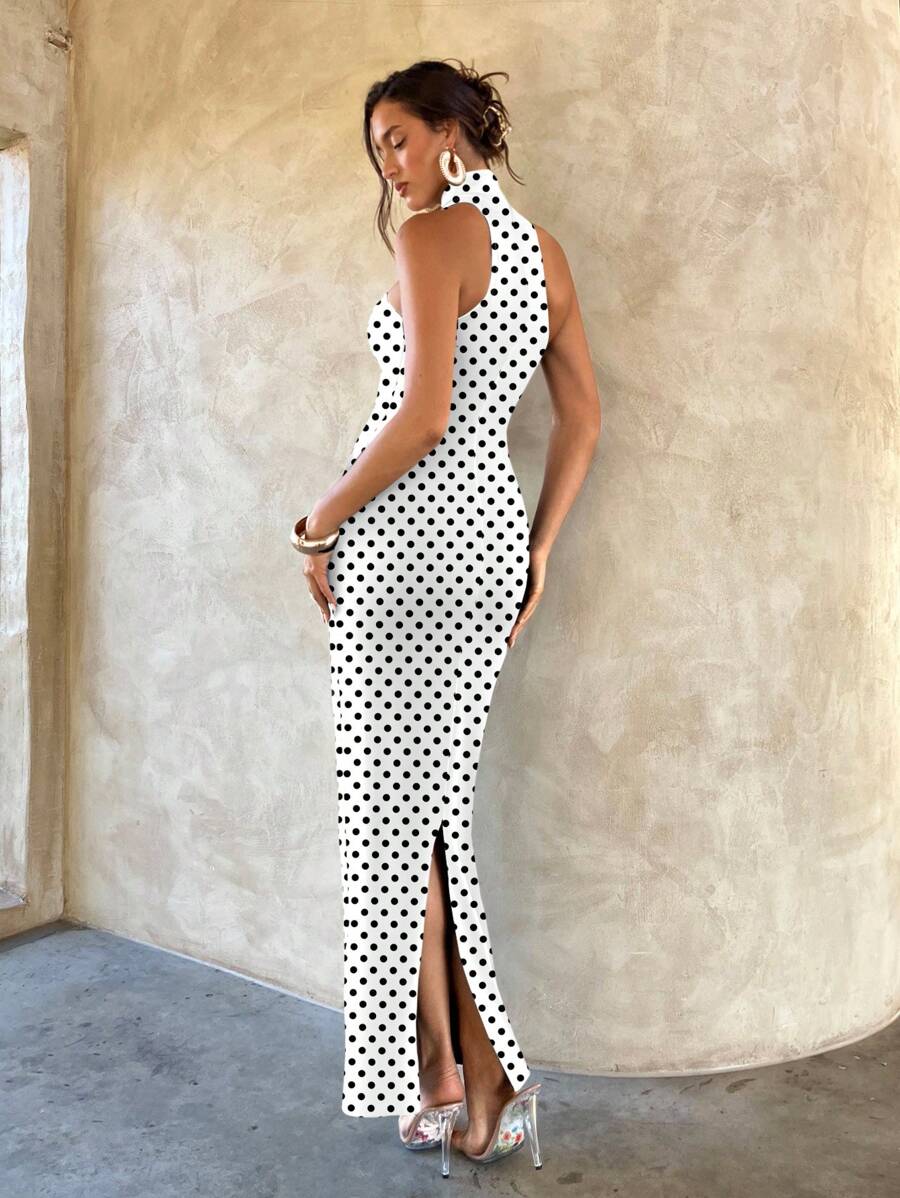 Back view of white polka dot halter maxi dress with rear slit and fitted shape