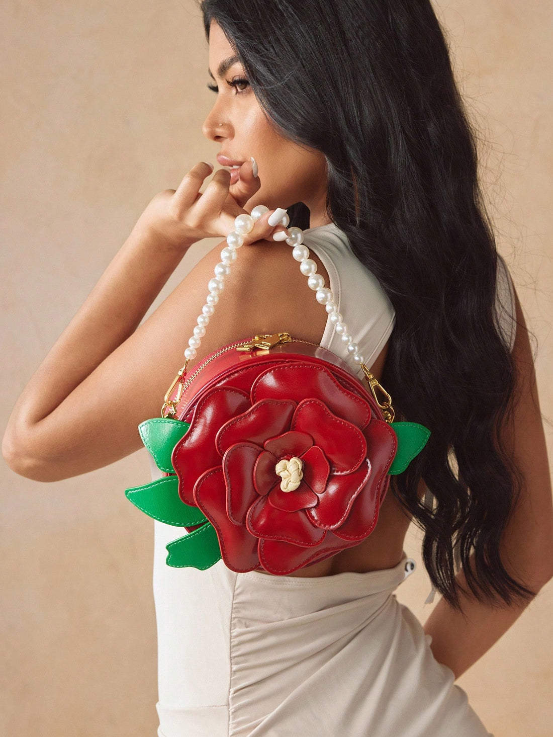 Add a splash of charm to your outfit with this playful red pearl handbag! Shaped like a delicate flower and crafted from smooth PU leather, it’s the perfect little top handle bag to brighten up parties or special occasions. Compact yet eye-catching, this unique accessory brings a fun and elegant twist wherever you go.