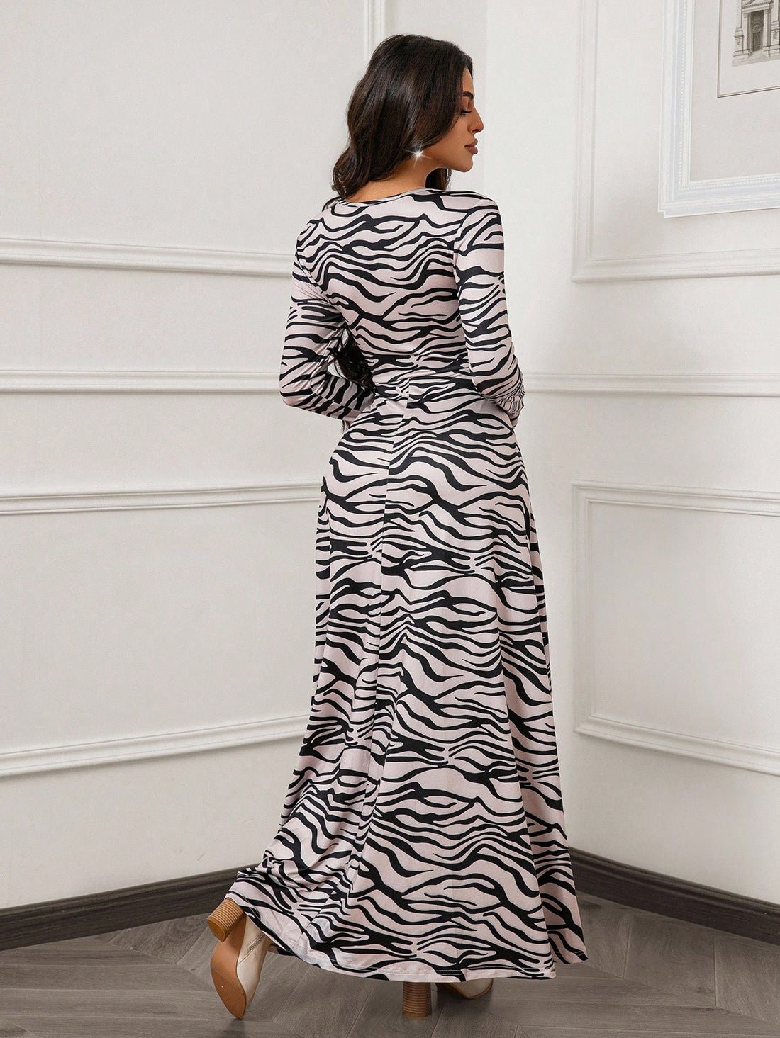 Step out in style with this Elegant Apricot & Black Wave Print Maxi Dress. Its fitted long sleeves and flared design create a flattering silhouette that's perfect for breezy spring and autumn days. The unique wave print adds a fun twist while keeping things sophisticated. Comfortable, chic, and ready for any occasion, this maxi dress is your new go-to for effortless elegance.