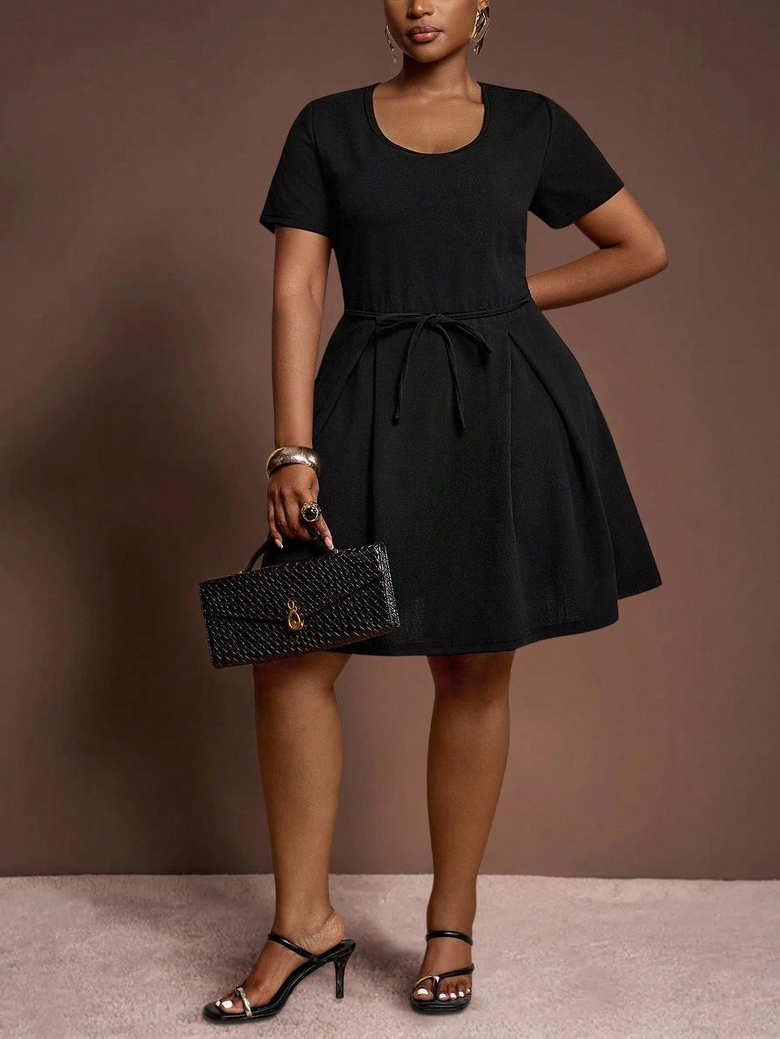 Turn heads in this chic plus size black mini A-line dress, designed to flatter your curves with a playful waist tie and graceful pleated details. Perfect for elegant occasions, it offers a fun yet sophisticated silhouette that moves with you. Dress it up or down and enjoy effortless style that's both comfortable and captivating.