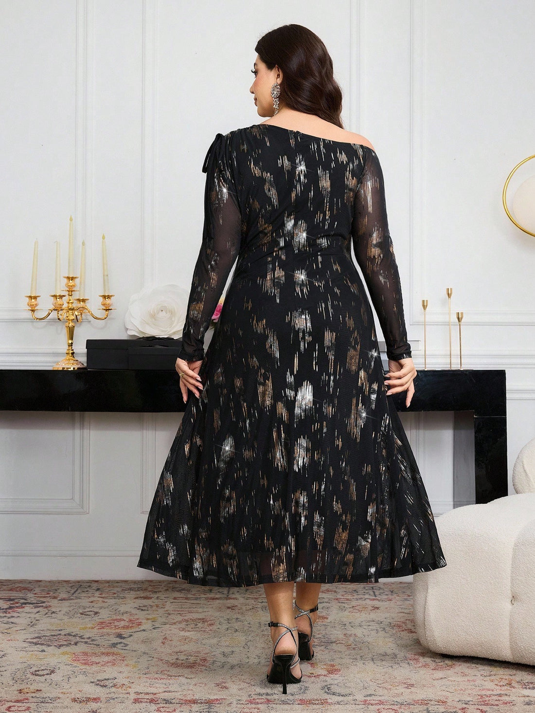 Elevate your autumn wardrobe with this sophisticated plus-size dress, featuring a striking metallic foil print that catches the light beautifully. The elegant ruffle detailing along the long sleeves adds movement and dimension, while the thoughtfully designed silhouette flatters and celebrates your curves. Perfect for seasonal gatherings, date nights, or elevated casual occasions, this piece combines eye-catching style with refined comfort. The metallic accents bring a touch of glamour to traditional fall t