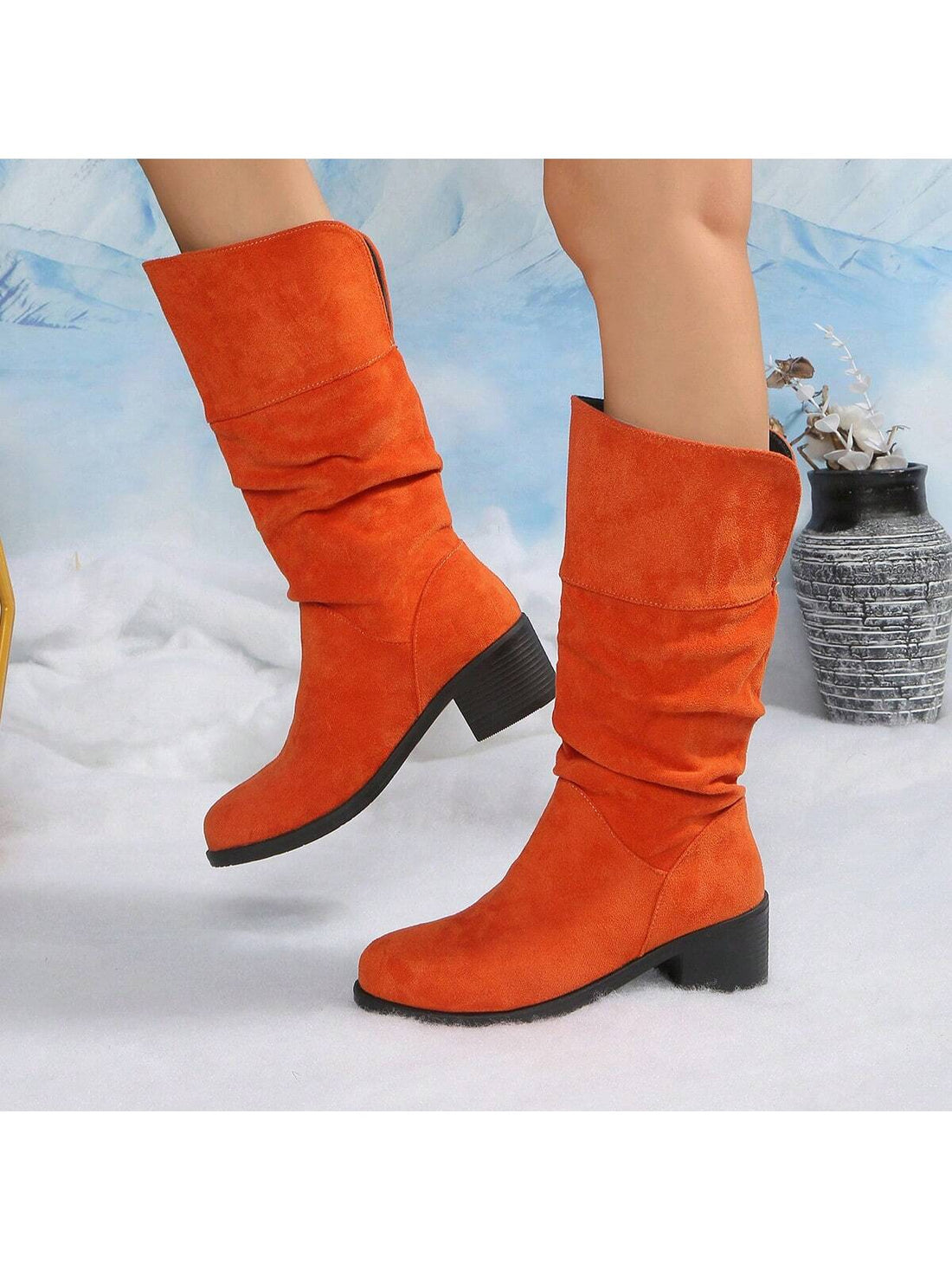 Step into winter with flair in these knee-high pleated boots designed just for fun-loving fashionistas. The cozy, slip-on style keeps your feet warm without any hassle, while chunky heels add a playful bounce to your stride. Perfect for chilly days when you want to stay snug and look effortlessly chic. Pair them with your favorite dress or jeans and watch your winter style soar!