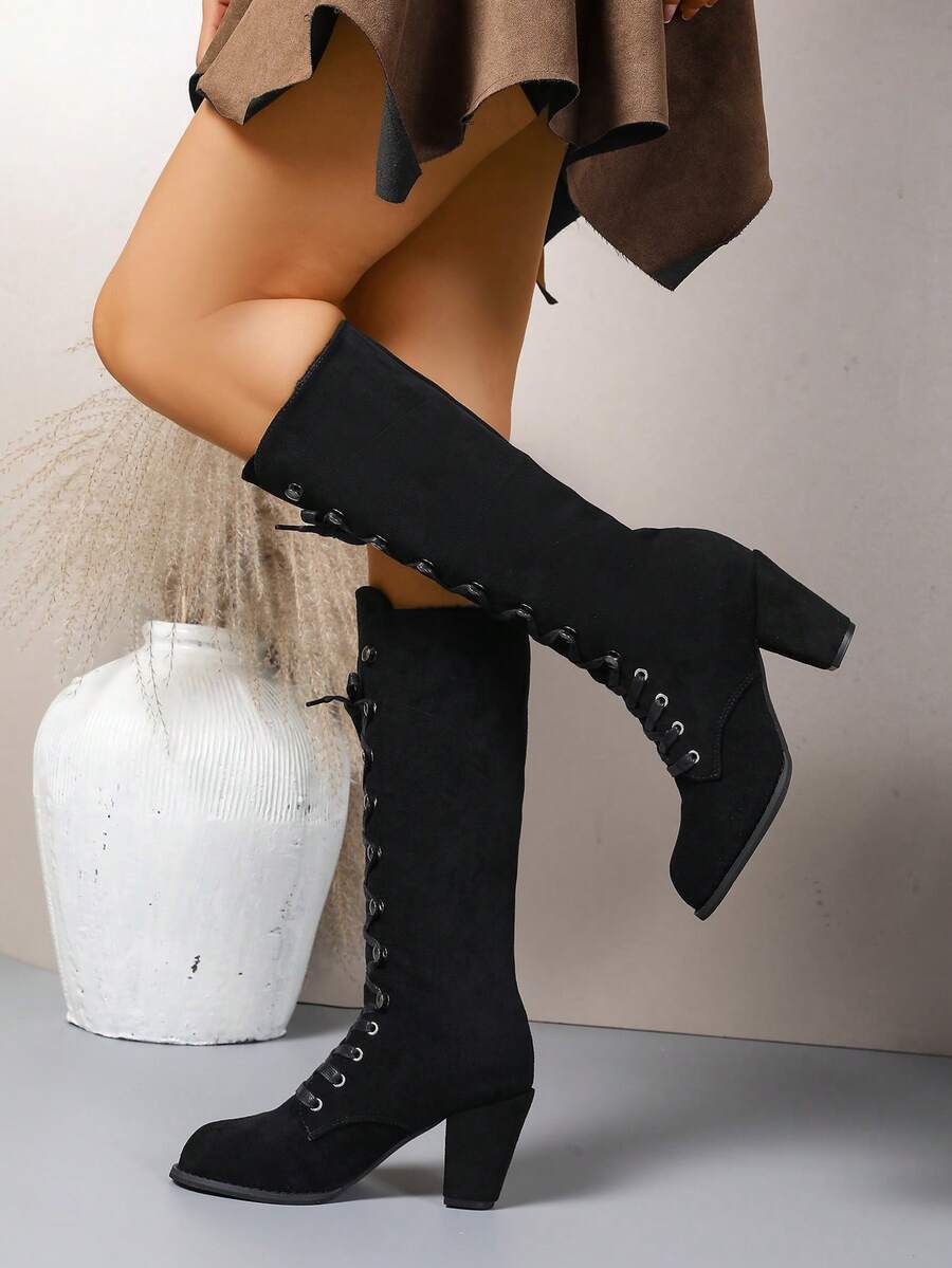 Step out in style with these elegant knee-high commuter boots! Featuring a sturdy chunky heel and eye-catching metal eyelets, they bring a playful edge to every outfit. Designed to keep you comfy and chic all year round, these boots are perfect for turning heads whether you're at work or a special event. Elevate your shoe game with a pair that's as versatile as your busy lifestyle!