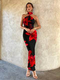 Front view of black red floral bodycon maxi dress with gold ring and clear heels