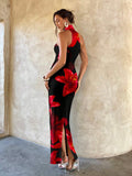 Back side view of black red floral halter maxi dress with back hem slit