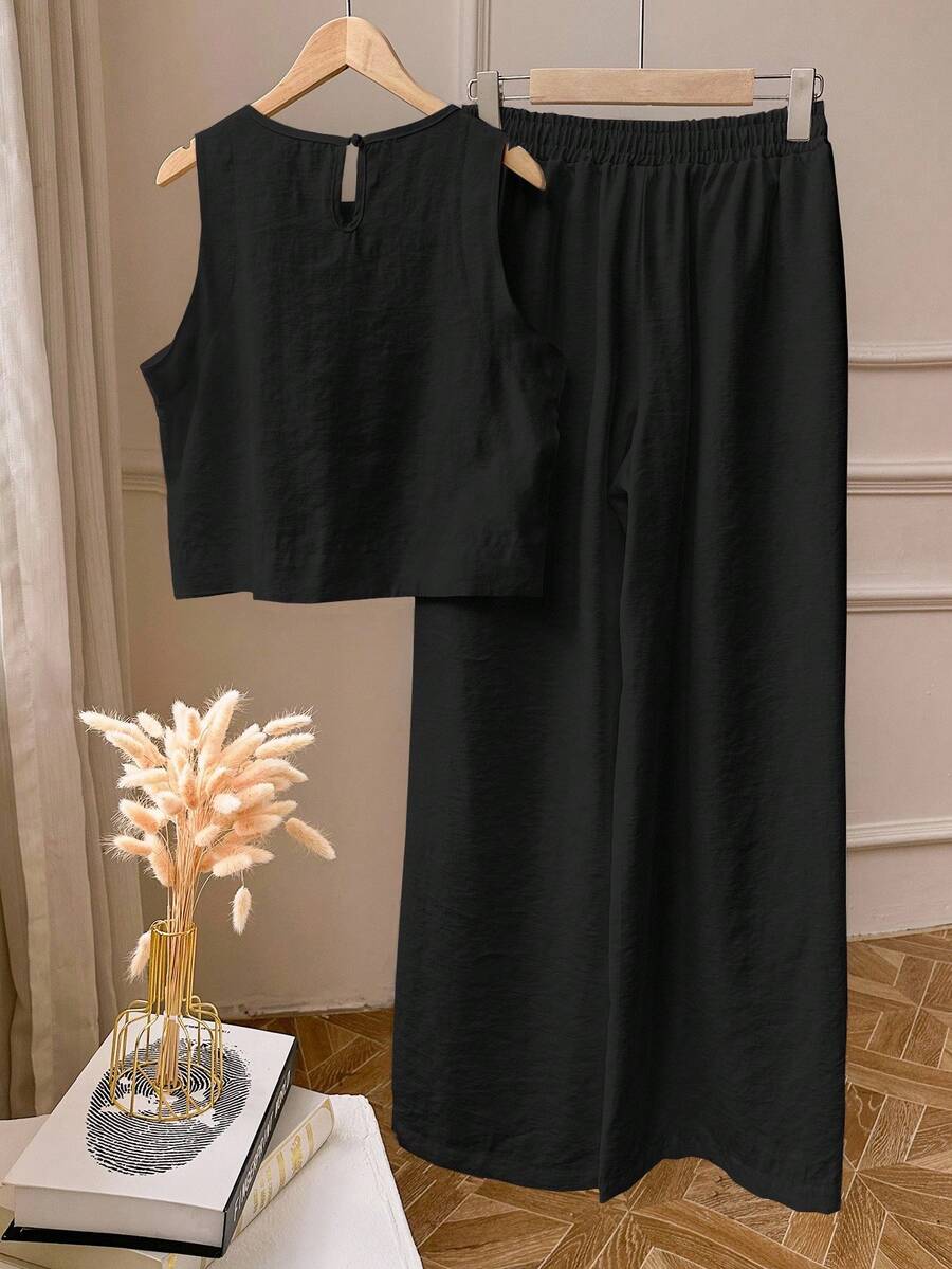 Elevate your everyday look with this fabulous two-piece set that's basically a style shortcut! The sleek sleeveless top pairs perfectly with matching leggings in a clean, solid color that goes with everything in your closet. Whether you're running errands, hitting the gym, or lounging at home, this effortless combo keeps you looking put-together without the fuss. Comfortable, versatile, and undeniably chic—because who says looking good has to be complicated?