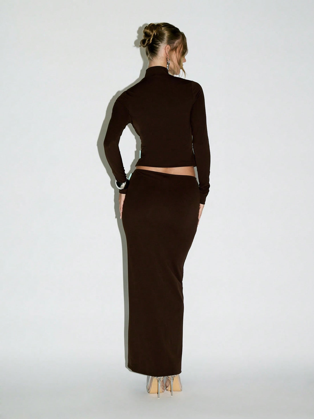Elevate your evening game with this stunning co-ord set that's equal parts sophisticated and fun! The cropped zip-through top features a chic mock neck that frames your face beautifully, while the flowing maxi skirt creates an effortlessly elegant silhouette. Mix and match the pieces for versatile styling, or wear them together for a show-stopping coordinated look. Perfect for date nights, parties, or whenever you want to feel absolutely fabulous. This is the kind of set that makes getting dressed feel like