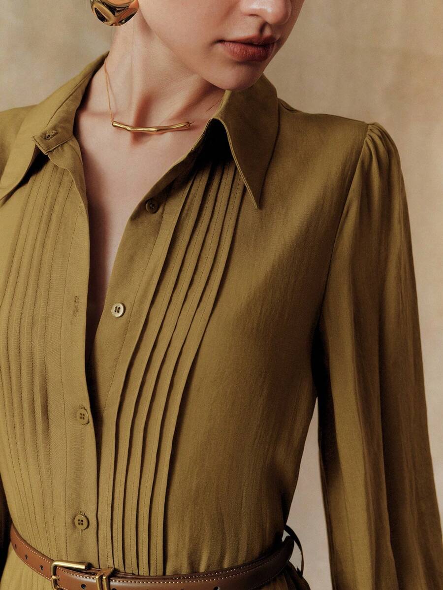 Elevate your seasonal wardrobe with this effortlessly chic pleated dress that's ready for anything. Crafted from breathable Tencel fabric, it features a flattering cinched waist that defines your silhouette while the button-down front adds a polished touch. The pleated design creates beautiful movement and dimension, making it perfect for breezy summer days or layered autumn looks. Versatile enough for casual outings or dressed-up occasions, this piece is your new go-to for looking put-together without tryi