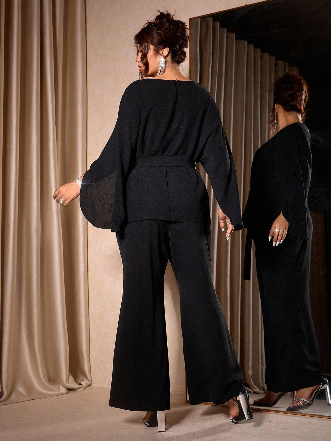 Celebrate the season in style with this stunning plus-size two-piece set designed to turn heads at every holiday gathering. The asymmetrical blouse features elegant draping that flatters your silhouette, while the flared pants offer comfort without compromising on sophistication. Perfect for festive dinners, parties, or casual holiday outings, this luxurious ensemble combines modern design with timeless elegance. Dress it up with heels and statement jewelry, or keep it chic with flats for an effortlessly po