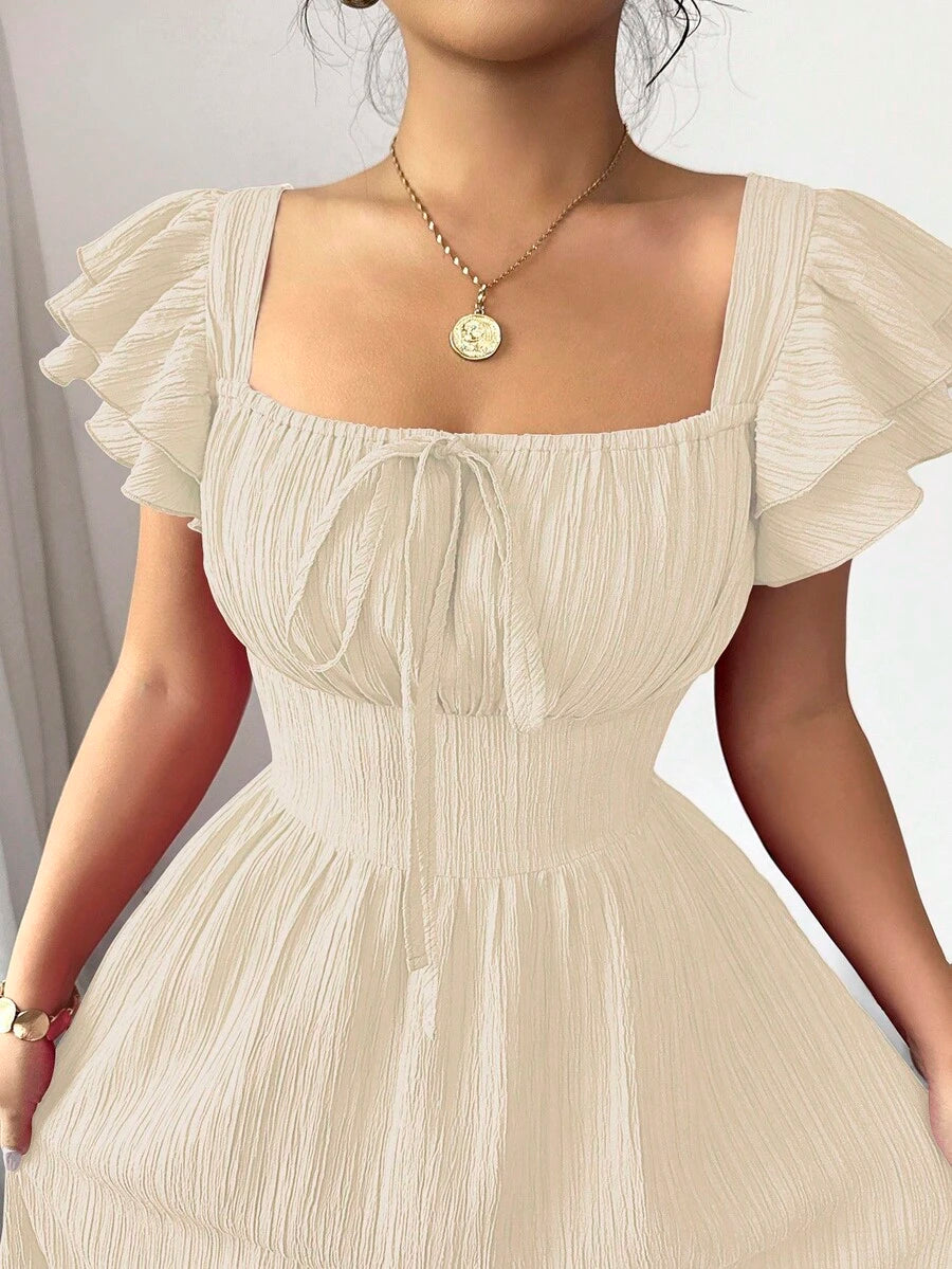 Experience the breathtaking fusion of romantic heritage and sharp, modern architectural tailoring. This stunning bow-tie back ensemble is meticulously designed for the woman who values a high-fashion, "quiet luxury" approach to seasonal dressing—the ultimate centerpiece for prestigious garden retreats, exclusive coastal soirées, and high-authority summer outings.