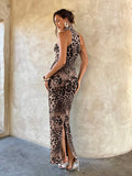 Back view of leopard print halter maxi dress with fitted silhouette and rear slit
