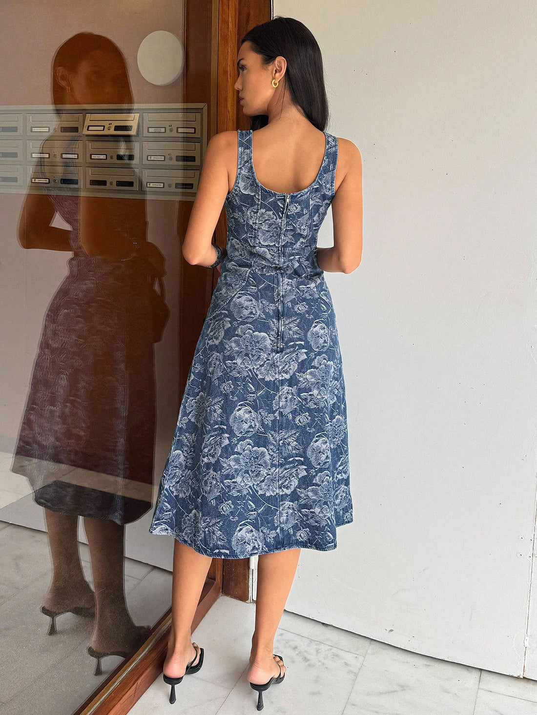 Crafted from premium denim, this sleeveless dress combines timeless sophistication with contemporary design. The intricate jacquard detailing adds visual interest and texture, while strategically placed front buttons offer both functional appeal and refined styling. Perfect for the modern professional, this versatile piece transitions seamlessly from office to weekend wear. The structured silhouette flatters various body types, and the denim fabric ensures durability through countless wears. An essential wa